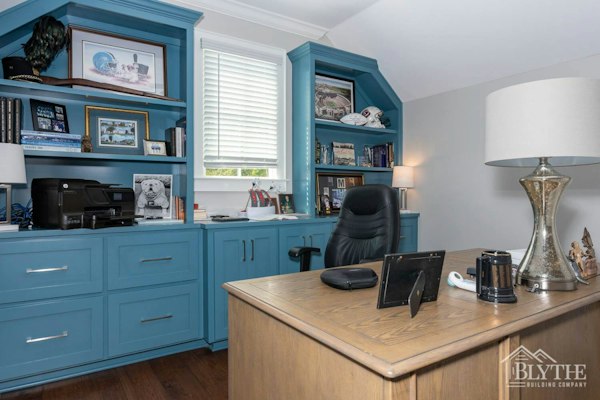 Custom office with blue built-in shelves and book cases