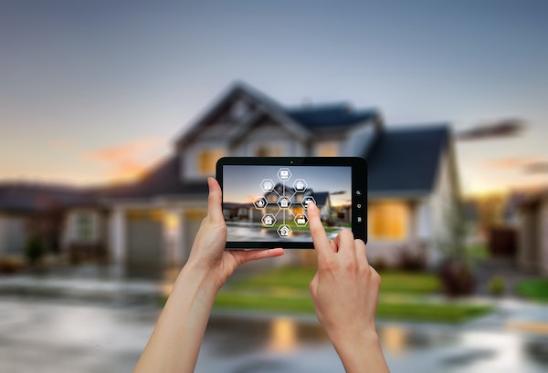Luxury-home-at-twilight-and-smartphone-with-smart-home-technology.jpg