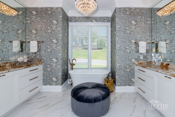 Maximalist bathroom with wallpaper and chandelier