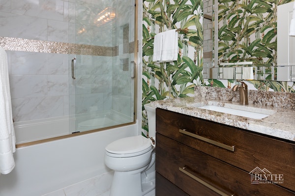 Maximalist bathroom with tropical wallpaper