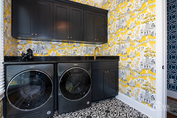 Maximalist design laundry room with wallpaper and patterned floor tile
