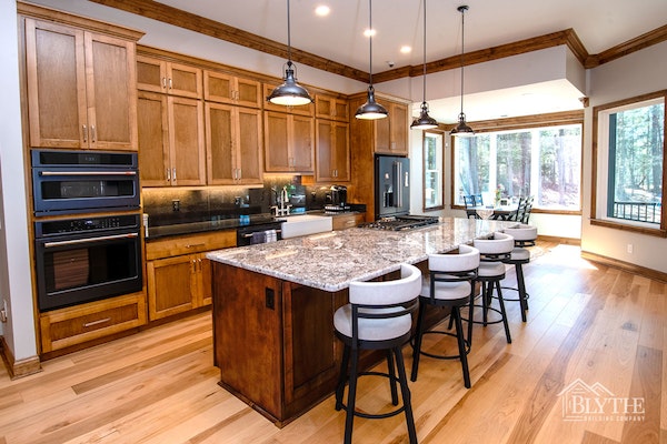 Custom Kitchen With Large Island Wood Cabinets Heavy Wood Molding And Hardwood Floors