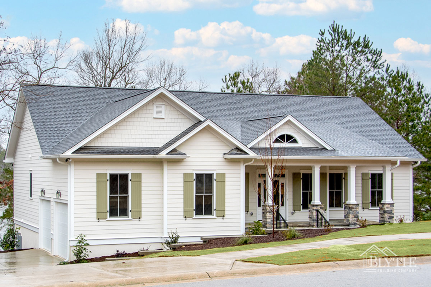 One-story Modern Craftsman with multiple gable details and front porch and green board and batten shutters on Lake Carolina.