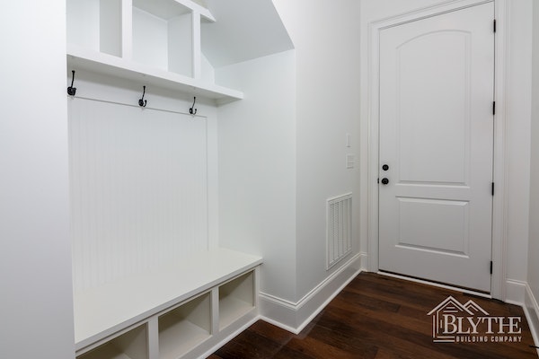 Beadboard in a mudroom with built-in bench and cubbies
