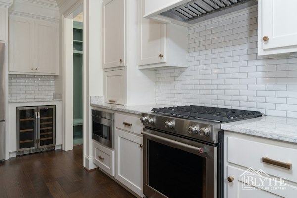 White Kitchen With White Shaker Cabinets White Subway Tile Stainless Appliances Dry Bar And Wine Cooler Under The Counter 1