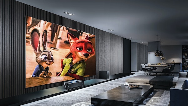 Luxury home movie theaterwith large screen, dark gray walls, and light gray carpet