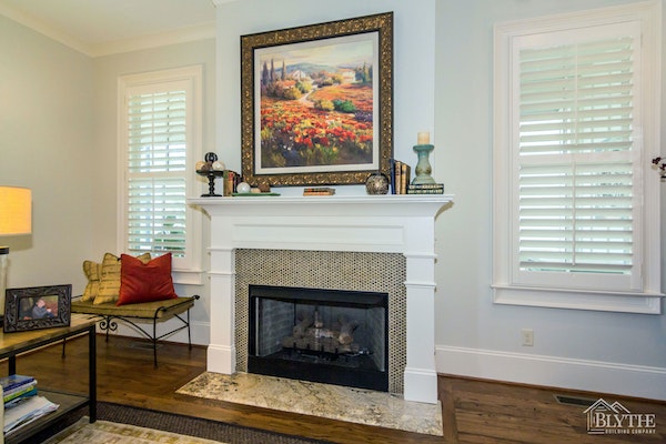 Small round tile fireplace surround and granite hearth.