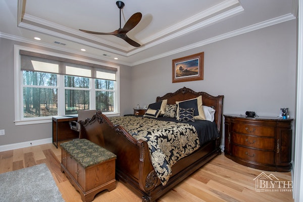 Master Bedroom With Wide Plank Hardwood Floors And Tray Ceiling 1