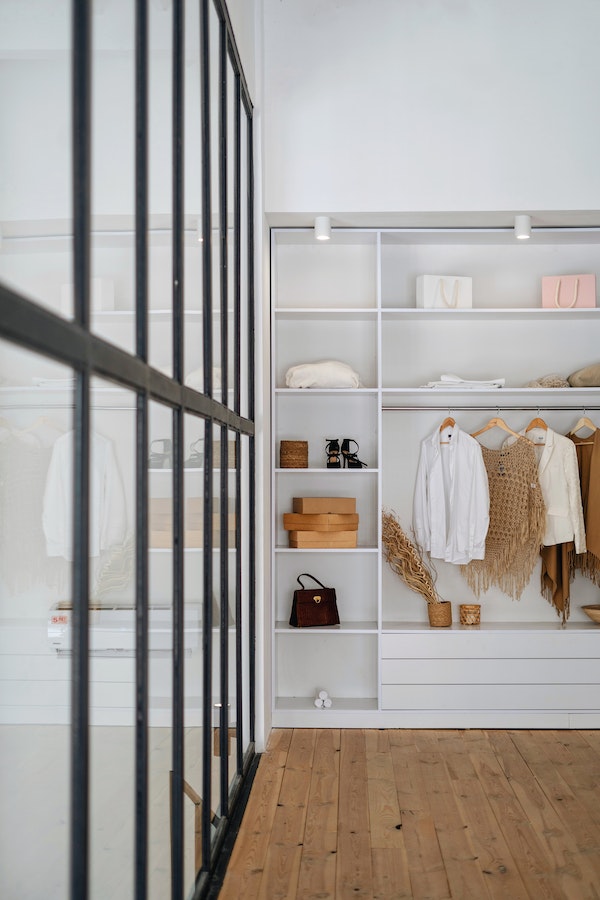 modern, large, white walk-in closet with mirrors