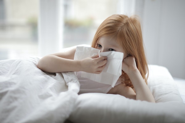 red-headed-girl-in-white-bed-with-tissue