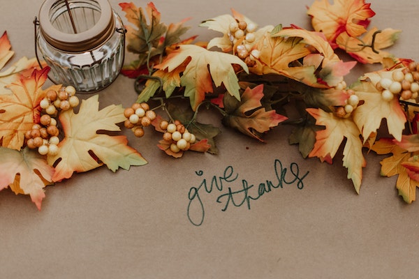 thanksgiving-table-decorations-with-fall-leaves-candle-and-words-give-thanks