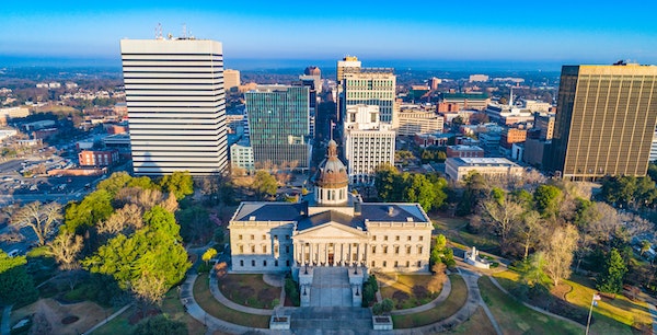 Aerial view of downtown Columbia, SC with the State House in the center looking down Main St.