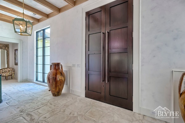 Double 4 Panel Door Entryway With Handmade Floor Tile Black Steel Windows And Patina Finish On The Walls