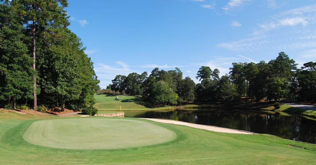 A view of one of the greens and a waterway with some woods on a sunny day on the Golden Hill Golf Course in Lexington, SC.