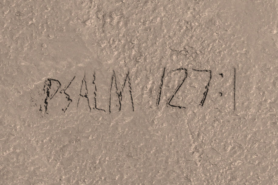 Wet cement with the inscription "Psalm 127:1"