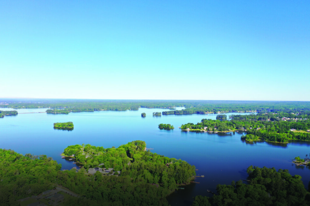 Drone view of Lake Murray and the WhiteWater Landing neighborhood on a sunny day with blue sky.